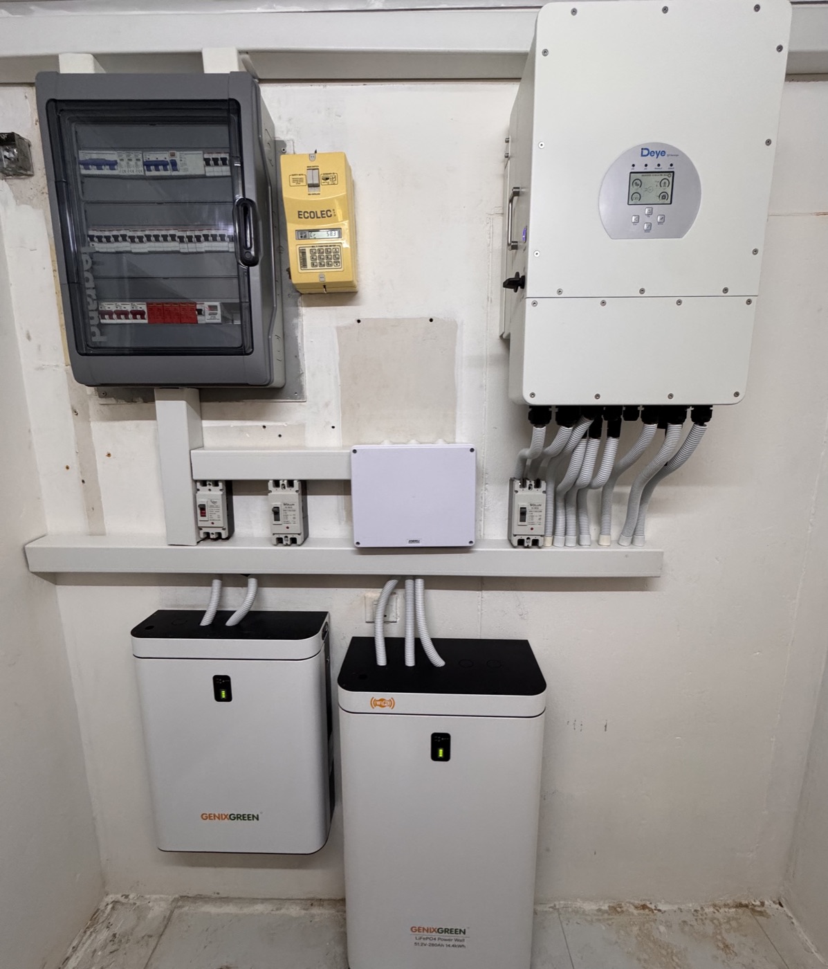 Deye hybrid inverter, ECOLEC prepaid meter, and GenixGreen LiFePO4 battery cabinets in the Zarena power room